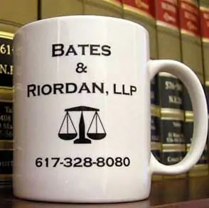 The Bates & Riordan coffee mug on the office law library bookcase.